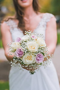 woman holding bouquet of purple and white roses thumbnail