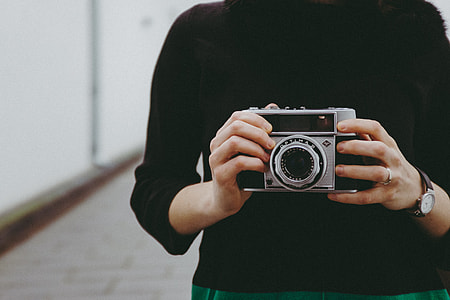 Girl holding a vintage camera thumbnail