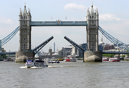grey suspension bridge under cloudy sky thumbnail