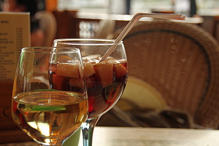 two 3/4-filled and 1/2-filled clear drinking glasses selective focus photo thumbnail