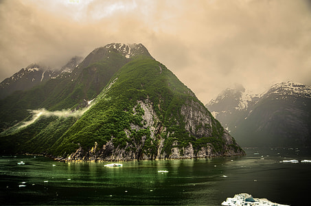 mountains surrounded by body of water thumbnail