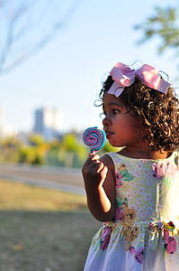 girl's holding multicolored lollipop thumbnail