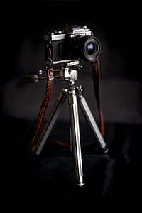 shallow focus photography of black and gray camera on tripod thumbnail