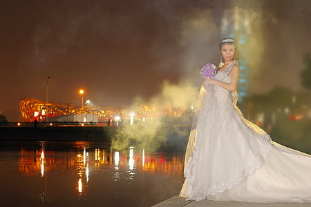 woman wearing wedding dress beside body of water thumbnail