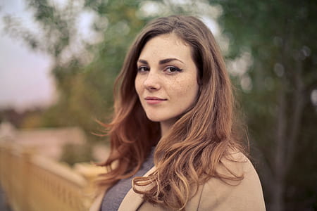 Closeup Photo of Woman With Brown Coat and Gray Top thumbnail