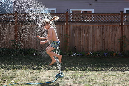 Girl Playing on Field With Sprinkle of Waters thumbnail