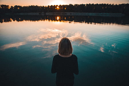 woman wearing black top while watching lake thumbnail