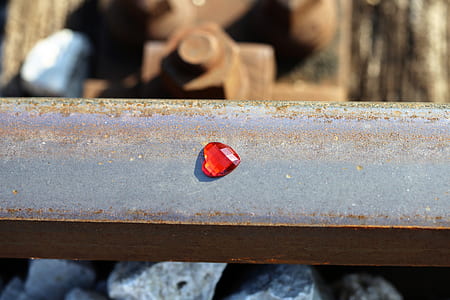 red heart gemstone on gray metal beam thumbnail