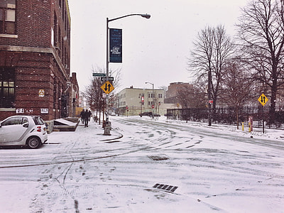 snow covered road near bricked building thumbnail