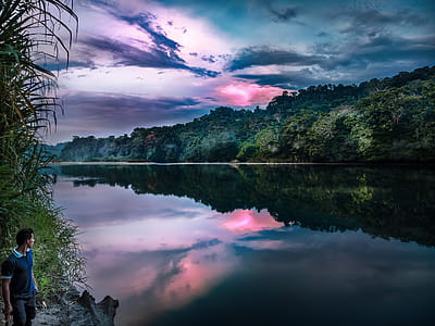 Man Standing Near Calm Body of Water thumbnail