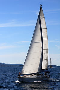 white and gray sail boat on body of water thumbnail