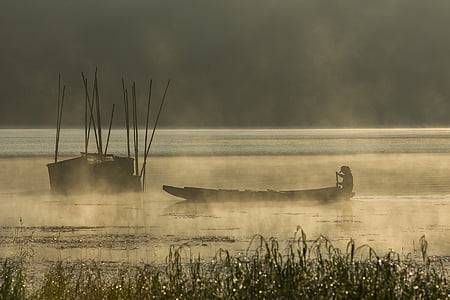 person rowing boat on a lake during golden time thumbnail