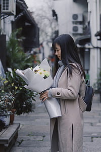woman holding a bouquet of flowers thumbnail