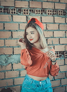 Woman in Orange Long-sleeved Shirt With Blue Denim Bottoms thumbnail