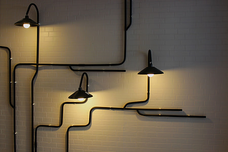 black steel wall mount three lights on white painted wall thumbnail