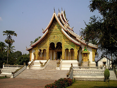 yellow and white temple near green trees at daytime thumbnail