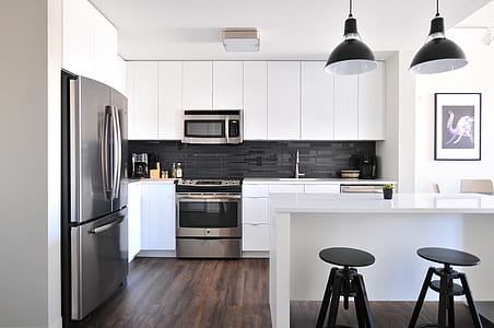 silver French-door refrigerator near black wooden stool chairs at kitchen thumbnail