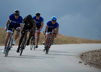 four man riding bicycles on asphalt road thumbnail
