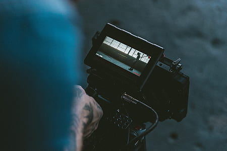 man holding black video camera thumbnail