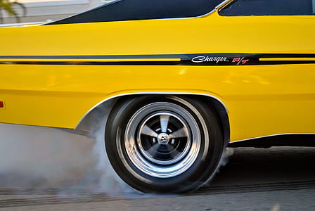 classic yellow Dodge Charger coupe on concrete road thumbnail