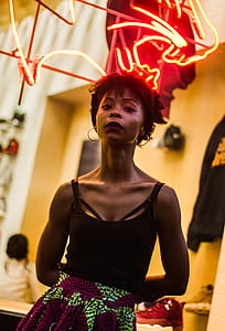 woman standing near cat neon sign thumbnail