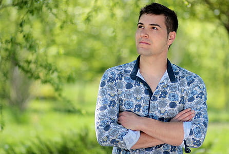 man wearing blue and black floral button-up long-sleeved shirt thumbnail