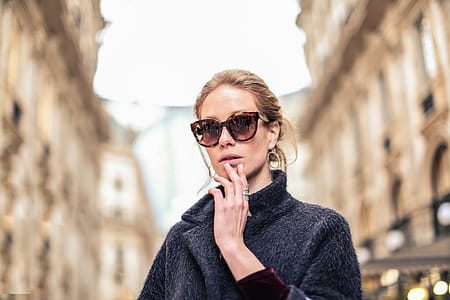 Woman Wearing Black Coat and Brown Framed Sunglasses thumbnail