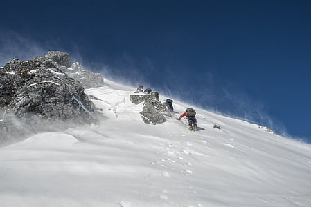 person climbing on snowy mountain thumbnail