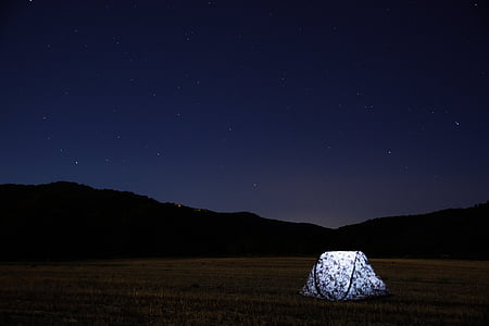 camping tent near mountain during nighttime thumbnail