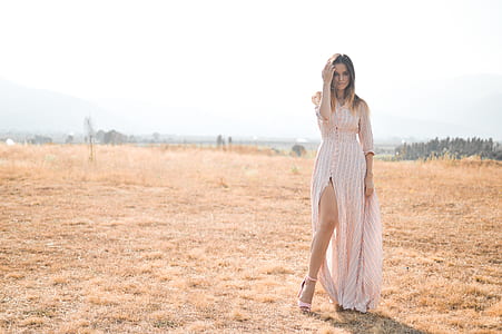 woman wearing pink and white elbow-sleeved side-slit dress thumbnail