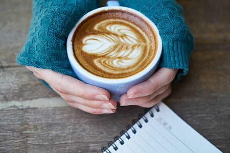 person holding poured teacup thumbnail