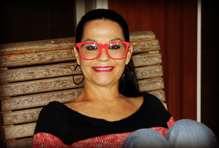 woman wearing red-frame eyeglasses sitting on chair thumbnail