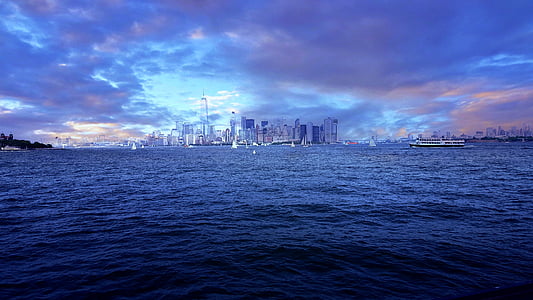 city by the harbor under grey cloudy sky thumbnail