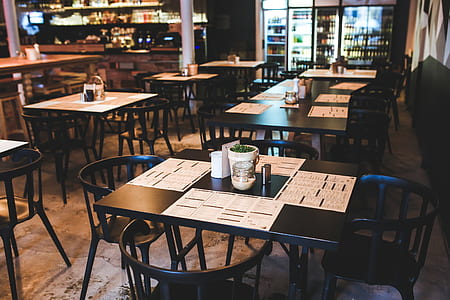 tables and chairs inside building near counter thumbnail