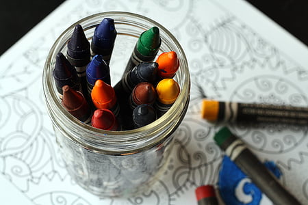 assorted-color crayons in clear glass jar thumbnail
