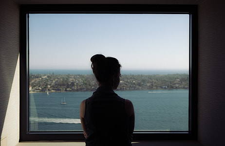 woman facing glass window thumbnail