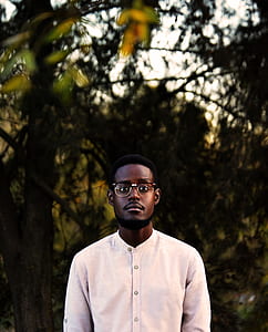 selective focus photo of man wearing beige button-up long-sleeved shirt thumbnail