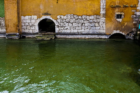 body of water near yellow wall thumbnail
