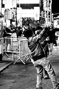 grayscale photography of man pointing on his right side thumbnail