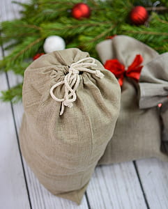 top view of brown drawstring pouch on white wooden surface thumbnail