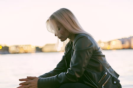 Selective Photography of Woman Sitting Near Body of Water thumbnail