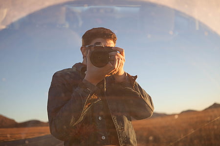 man capturing using his camera during daytime thumbnail