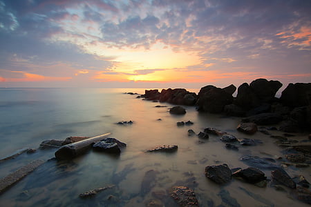 photo of sea boulders during golden hour thumbnail