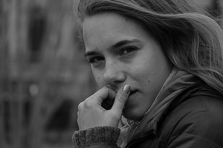 grayscale photo of woman with hand on her mouth thumbnail
