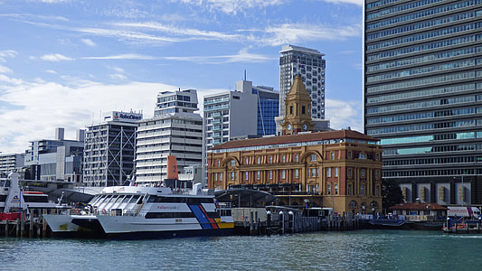 gray concrete buildings beside body of water thumbnail