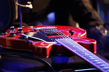 selective focus photography of red jazz guitar thumbnail