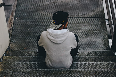 man sitting on gray staircase thumbnail