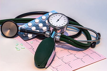 blood pressure monitor on top of pink printed paper thumbnail