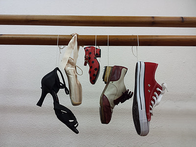 five assorted footwears hang on bamboo shallow focus photography thumbnail