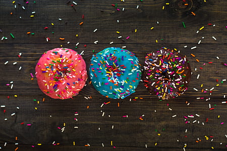 three assorted-color donuts with sprinkles thumbnail